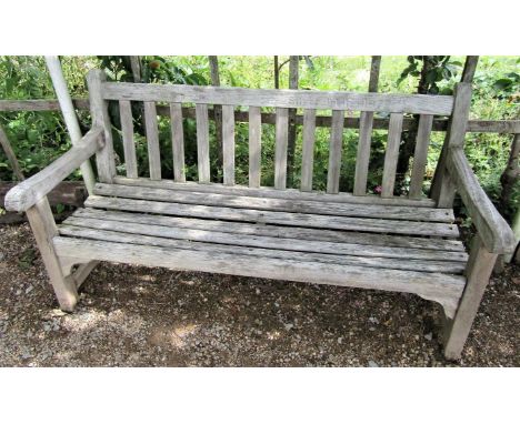 A weathered teak wood garden bench to commemorate the 1977 Silver Jubilee, 153cm wide 