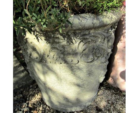 A pair of reconstituted garden urns of circular tapering form, with repeating scroll and floral detail, 50cm high 