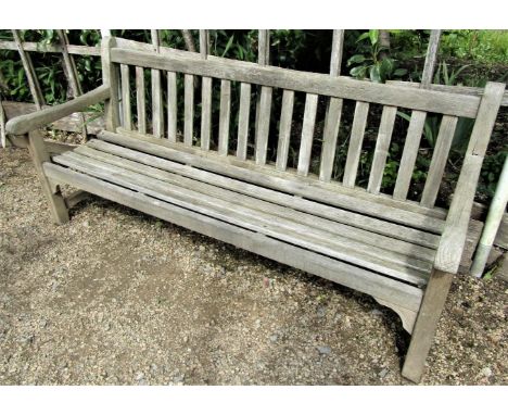 A weathered teak wood garden bench, to commemorate the 1977 Silver Jubilee, 180cm wide 