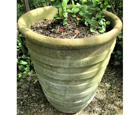 A weathered garden planter of tapering ribbed form (af) 70cm high 