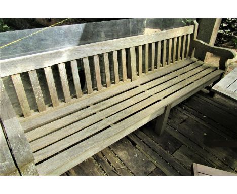 A good quality weathered teak garden bench, 240cm wide 