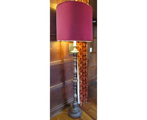 A turned timber lamp standard, with repeating baluster turned stem raised on a circular disc base, 53cm high to bulb holder 