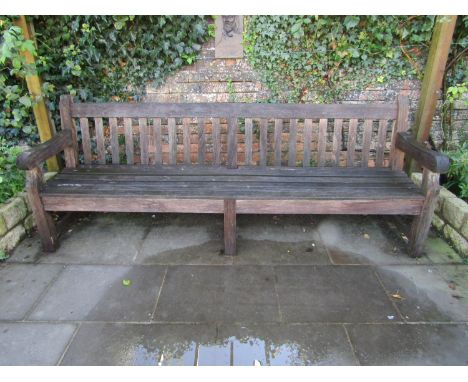 A good quality weathered teak park bench, 240cm wide 
