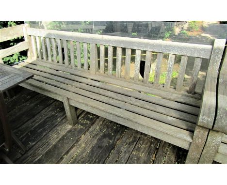 A good quality weathered teak garden bench, 240cm wide 