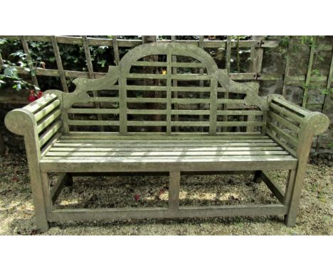 A weathered teak wood garden seat in the Lutyens manner, 165cm wide 