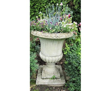 A reclaimed campana shaped garden urn with fluted panels, within egg and tongue borders, 75cm high 