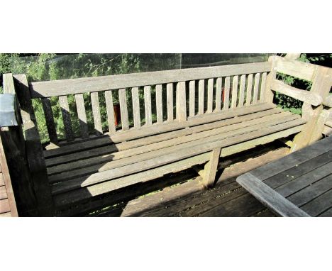 A good quality weathered teak garden bench, 240cm wide 