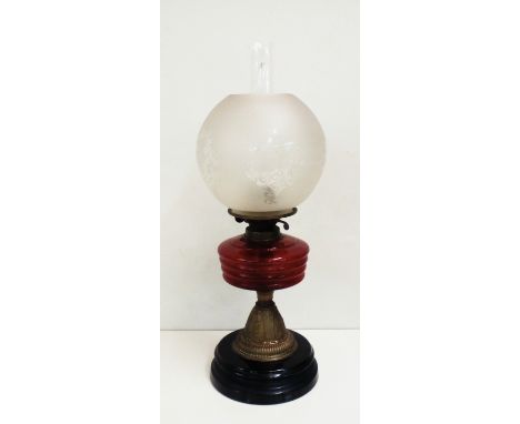 Victorian oil lamp with red reservoir , height 57cm