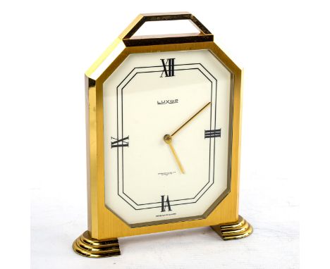 LUXOR - a Vintage brass-cased mantel clock, retailed by Garrard & Co Ltd, white enamel dial with quarterly Roman numeral hour