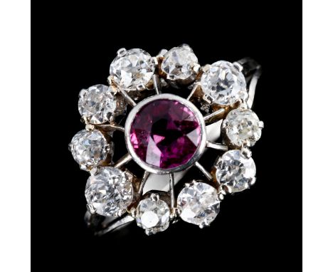 An Antique platinum "ruby" and diamond cluster target ring, set with old European-cut ruby and old-cut diamonds, total diamon