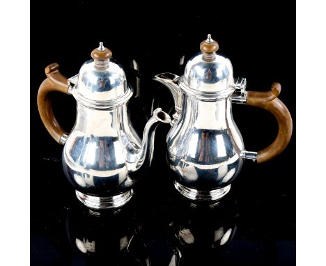 A George VI matching silver bachelor's coffee pot and hot water jug, baluster form with turned wood handles, by Goldsmiths & 