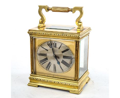 A large French brass-cased carriage clock, by L Vincent of Avignon, oval silvered dial with Roman numeral hours markers, blue