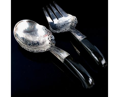 A pair of Middle Eastern unmarked silver horn-handled salad servers, pierced and engraved floral decoration with Arabic scrip