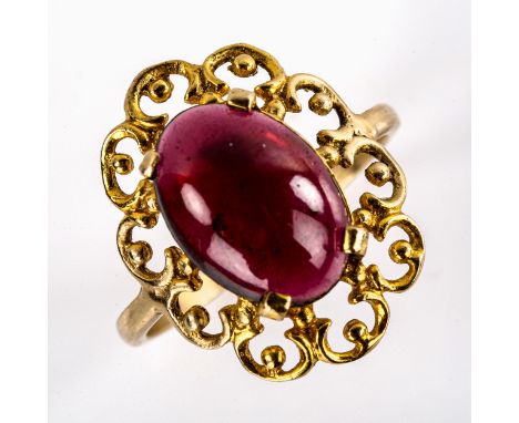 A large late 20th century garnet dress ring, openwork settings with oval cabochon garnet, setting height 21.9mm, size approx 