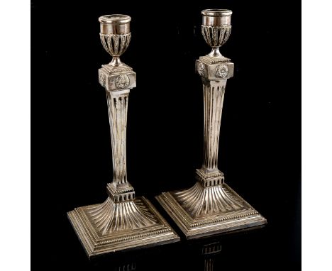 A pair of Dutch silver table candlesticks, fluted decoration with relief embossed roundels and beaded borders, height 25cm, l