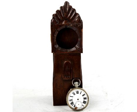 A stained oak pocket watch stand, modelled as a longcase clock, overall height 23cm, pocket watch opening 5cmHinges have been