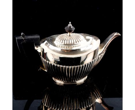 A late Victorian silver teapot, oval half fluted form with turned ebony mounts, by John Round & Sons Ltd, hallmarks Sheffield