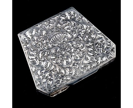 A Continental silver compact, trapeze form, with allover foliate engraved decoration, engraved 800, width 9cm, 2.7ozNo damage