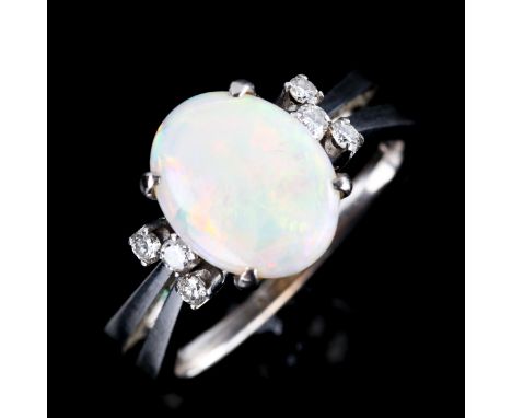 A late 20th century 14ct white gold dress ring, set with oval cabochon white opal and round brilliant-cut diamonds with split