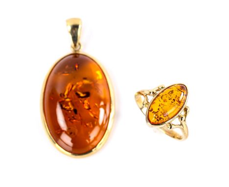 A modern 9ct gold Baltic amber matching ring and pendant set, ring size M, pendant height excluding bale 34.6mm, 7g total (2)