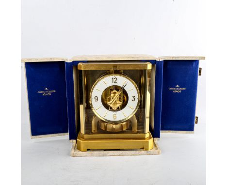 JAEGER LECOULTRE - a Vintage brass-cased Atmos clock, white chapter ring with gilt quarterly Arabic numerals and glass exhibi