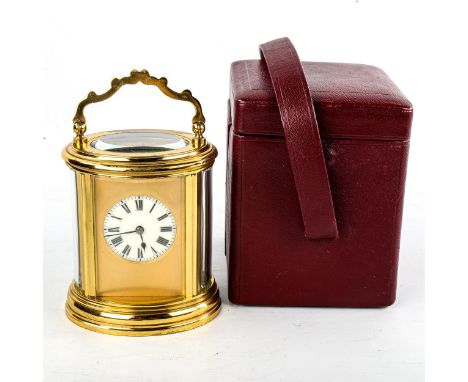 A French oval brass-cased chiming carriage clock, white enamel dial with Roman numeral hour markers, blued steel hands, bevel
