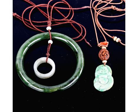 A jade slave bangle, on cord pendant mount with jade ring, and another carved and polished jade Buddha pendant, with carved n