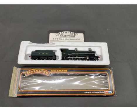Mainline Railways 00 Gauge 4-6-0 Manor class engine and tender in GWR green livery boxed (slight damage) but on mint unused c