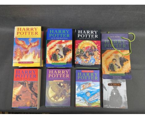 3 x first edition Harry Potter books along with an original paper bag for the Half blood prince and 4 paperback later copies 