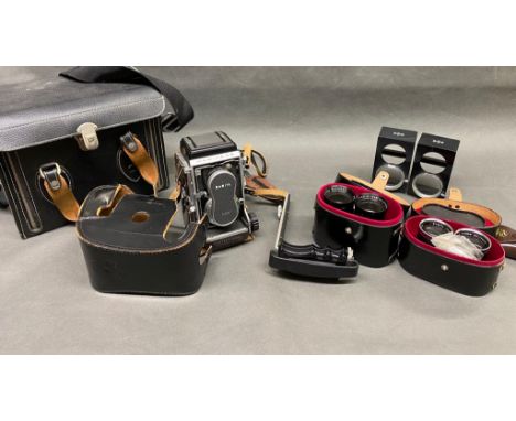 A vintage Mamiya C3 camera with lenses and case