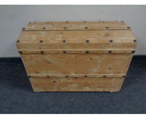 An antique stripped pine shipping trunk 