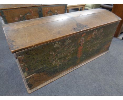 A 19th century oak dome topped shipping trunk with hand painted decoration and key 
