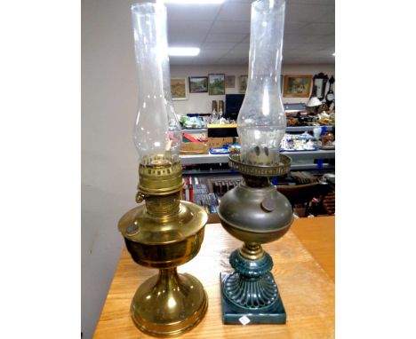 An Aladdin brass oil lamp with chimney together with a further oil lamp with ceramic base with chimney 