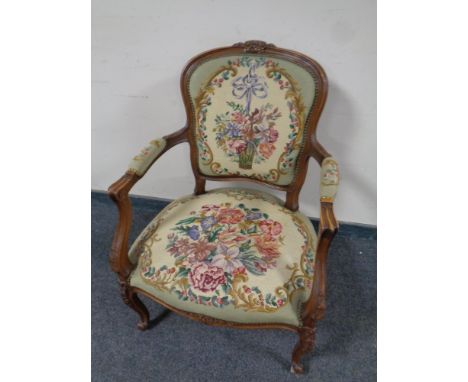 A French style carved beech salon armchair upholstered in tapestry fabric 