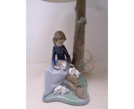 A Nao figural table lamp - seated girl with rabbits, with shade 