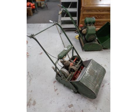 A vintage Atco petrol lawn mower with grass box and roller 