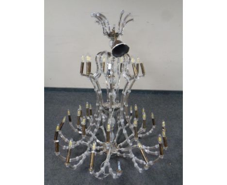An impressive contemporary metal and glass nine arm thirty-six light chandelier  