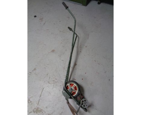 A vintage self drive lawn edger 