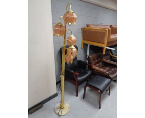 A brass five way floor lamp with glass shades (continental wiring) 