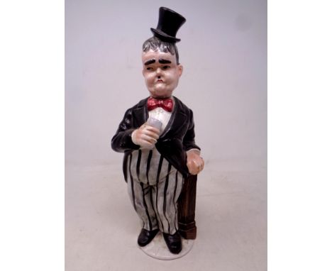 A vintage ceramic Oliver Hardy decanter, height 31 cm 