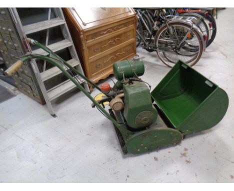 A vintage Ransomes model 3 Meteor 4 petrol lawn mower with grass box 