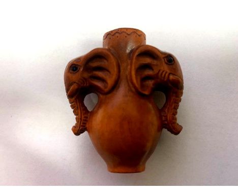 A Japanese carved fruitwood netsuke - Vase With Elephant Head Handles. 