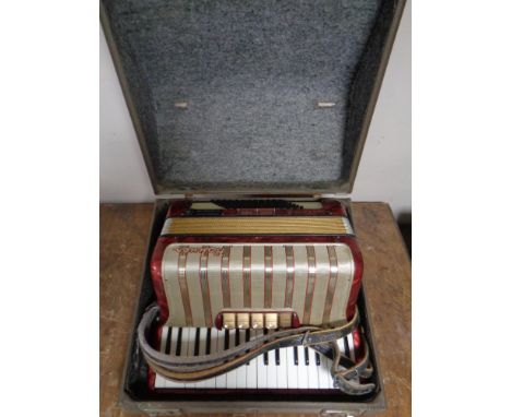 A Hohner piano accordion in case 
