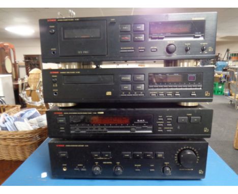 A four piece Luxman stack system - stereo cassette deck K-322, compact disc player D-322, digital synthesizer stereo tuner T-