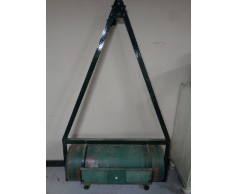 A garden roller with metal lawn mower bracket 