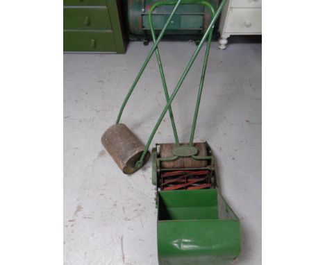 A vintage Monitor Push lawn mower with grass box together with further garden roller 