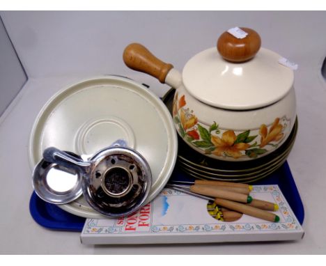 A tray of fondue set with forks and four ceramic dishes 