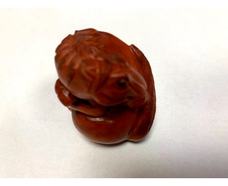 A Japanese carved fruitwood netsuke - Horse. 