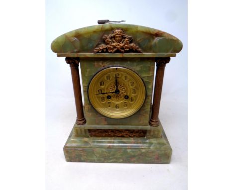 A 19th century onyx mantel clock with Corinthian column supports and key 