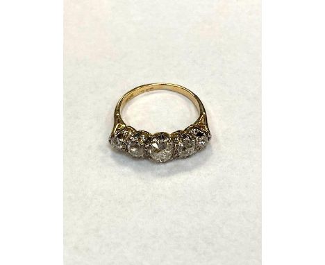 An 18ct gold and platinum set five stone graduated old cut diamond ring, approximately 1.5ct, size J/K.